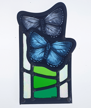 Load image into Gallery viewer, Blue butterflies above green glass
